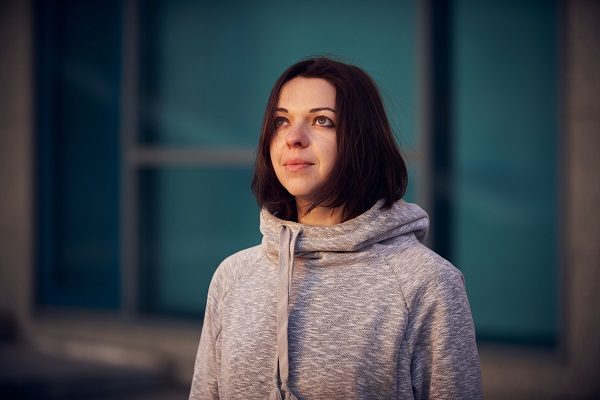 Woman in mask on street because epidemic of coronavirus in city. Protection against virus and infection