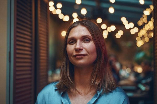 Woman portrait, in a cafe close up dreamy facial expression